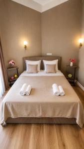 a bedroom with a large bed with two towels on it at Sheki Secret Garden Boutique Hotel & Guest House in Sheki
