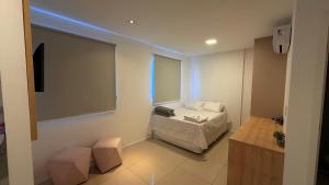 a small room with a bed and a window at Studio V Ininga in Teresina