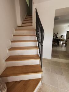 a staircase in a house with wood and metal railings at B&B Il Merlino in Chiaserna