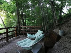 a couch sitting on a table in the woods at B&B Il Merlino in Chiaserna