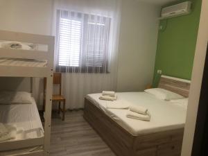 a bedroom with two bunk beds and a window at FIORE Seaview Rooms - Premium Location in Selce