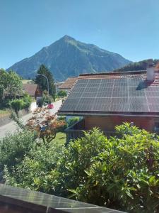 a group of solar panels on the roof of a house at 1 Zimmer Unterkunft in Spiez