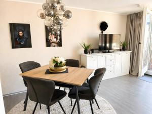 a dining room with a wooden table and chairs at Schwarzwaldloge Zeitlos in Sasbachwalden +13 photos