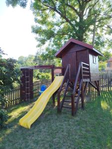 a playground with a slide and a play house at Domaćinstvo Nikolić-Milicevo Selo in Požega