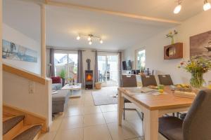 a living room and dining room with a table and chairs at Strandhaus Bernstein in Breege in Breege