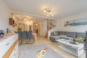 a kitchen and living room with a couch and a table at Strandhaus Bernstein in Breege in Breege