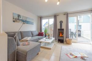 a living room with a couch and a fireplace at Strandhaus Bernstein in Breege in Breege