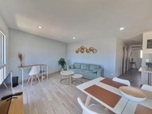 a living room with a blue couch and a table at Lana #Clim#Terrasse - Meublé classé 3étoiles in Clermont-Ferrand