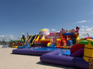 a large inflatable water park on the beach at Olivina Park Spa - domki z dostępem do krytego basenu, saun, wyżywienia i atrakcji dla dzieci in Niechorze +160 photos
