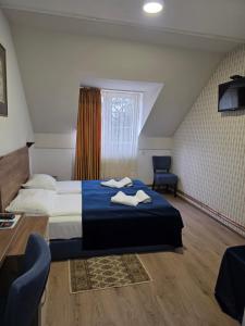 a hotel room with a bed and a chair at Hotel Pepa in Divčibare