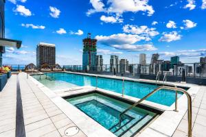 a swimming pool on the roof of a building with a city skyline at The York Suite Miami in Miami