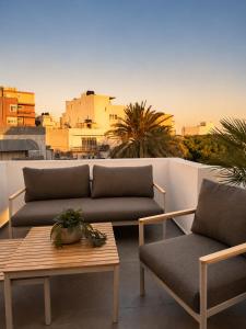 a living room with two couches and a table at Cabana Condo in Ierapetra