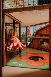 a childrens play area with a toy in a cage at Santa Villa & restaurant in Sremska Mitrovica