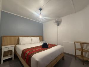 a bedroom with a bed and a fan at Ickota B&B in San Pedro de Atacama