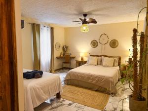 a bedroom with two beds and a table at Hotel Boutique Casa Mambo in Cahuita +58 photos