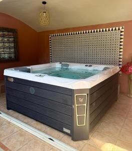 a large jacuzzi tub in a room at L'Hacienda in Mialet