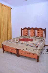 a bed with a wooden frame in a room at The White Grand Heritage in Balangoda