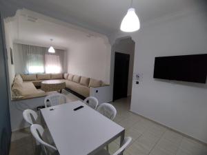 a living room with a white table and chairs at heartofrabat in Rabat