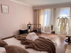 a bedroom with a bed with a blanket on it at Maison Rosé in Hasselt