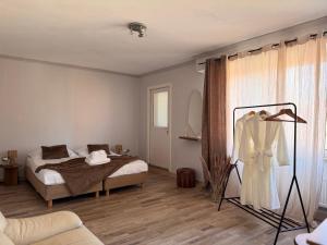 a bedroom with a bed and a dress on a rack at Maison Rosé in Hasselt +3 photos