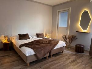 a bedroom with a bed with a blanket on it at Maison Rosé in Hasselt