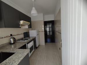 a kitchen with a stove and a refrigerator at heartofrabat in Rabat +8 photos