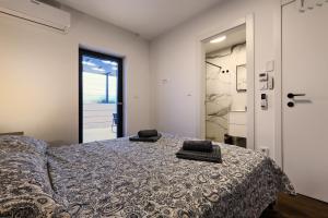 a bedroom with a bed with two pillows on it at Luxurious Sea-View 2BR Apartment with Private Pool-Villa Quadris-Crikvenica in Crikvenica +42 photos