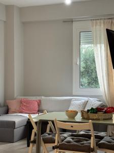 a living room with a couch and a table at Nefeli's apartment in Vonitsa