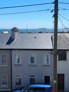 a white house with a car parked in front of it at Glenlara House in Youghal