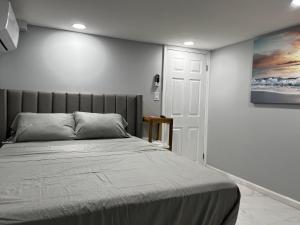 a bedroom with a bed and a painting on the wall at Lg2NY in Westerleigh