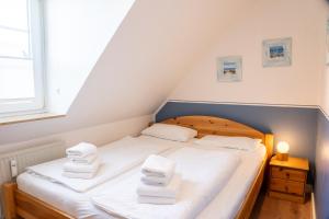a bedroom with a bed with towels on it at Lister Tor 01 in List