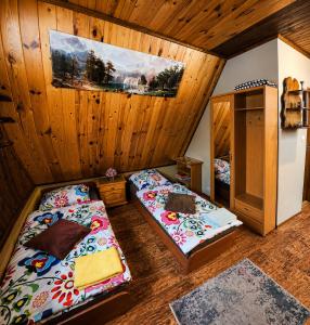 an attic room with two beds and a mirror at Noclegi u Marka in Czernichów
