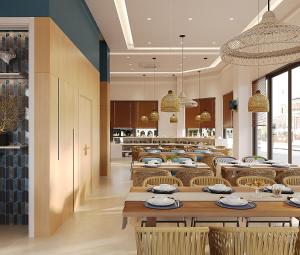 a restaurant with tables and chairs and a kitchen at TTC Lotus Hotel in Phú Quốc