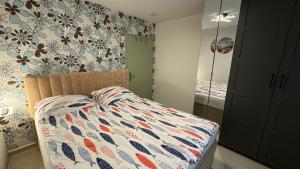 a bedroom with a bed and a mirror at Ferienhaus Am Vitzerod in Tambach-Dietharz