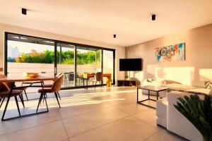 a living room with a table and a couch at Luxurious Sea-View 2BR Apartment with Private Pool-Villa Quadris-Crikvenica in Crikvenica