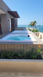 a swimming pool on the side of a house at Bello Horizonte, Aeropuerto, playa Dormida in Santa Marta