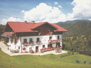 a building with a red roof on a hill at Vom Reiter in Schladming