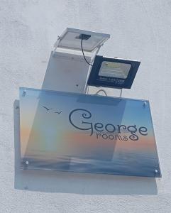 a box with a sign on the side of a building at George Rooms in Votsi