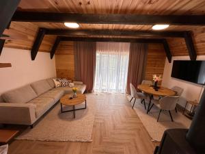a living room with a couch and a table at Durmitor Panorama in Žabljak
