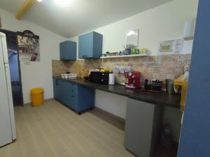 a kitchen with blue cabinets and a counter top at Casa FaRa in Vama Veche