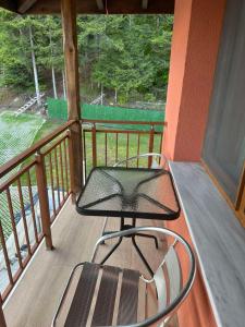 a balcony with a table and a chair on it at Вила Версай in Sarnitsa