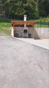 a skateboard ramp with a pavilion with a table at Вила Версай in Sarnitsa