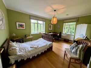 a bedroom with a bed and a desk in it at EinfachSein Zimmer in Trittau