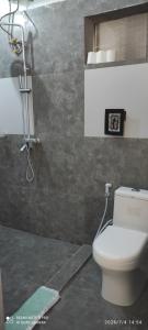 a bathroom with a toilet and a shower at Villa Mina beachhouse in Jambiani