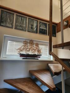 a model ship sitting on a shelf in a room at Tähe Holiday Home in Pärnu