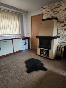 a living room with a fireplace and a stove at Tähe Holiday Home in Pärnu +20 photos
