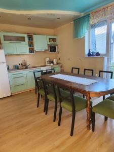 a kitchen and dining room with a table and chairs at Tähe Holiday Home in Pärnu