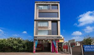 a tall building with a banner in front of it at HOTEL RAAS PLAZa in Kānpur