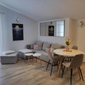 a living room with a couch and a table at Riviera Rooms and Apartments in Rab