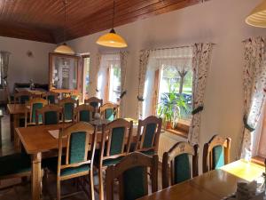 a dining room filled with wooden tables and chairs at Restaurace Staré Sedlo in Orlík